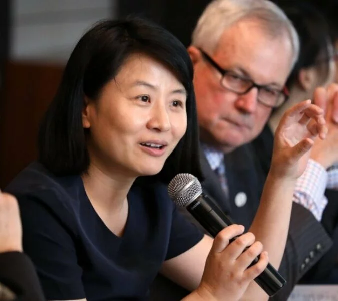 A woman speaks into a microphone