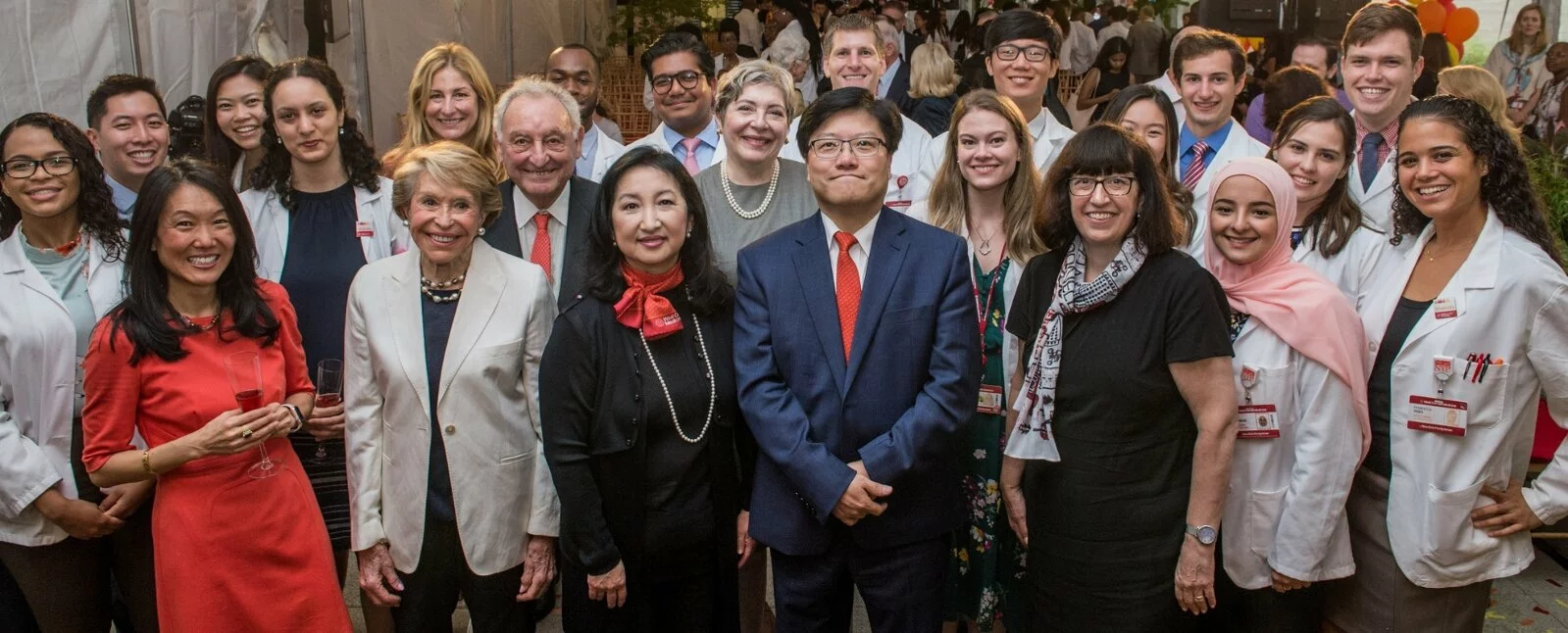 Lined up on a staircase, Mr. Greenberg, Mrs. Corinne Greenberg, and former President of The Starr Foundation Ms. Florence Davis with the Greenberg World Fellows at Yale University.